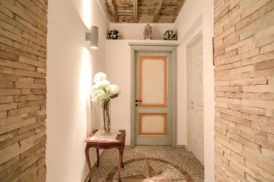 a vase of flowers on a table in a hallway at Orso Luxury Apartment in Rome