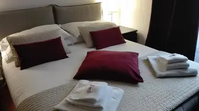 a bed with towels sitting on top of it at Orso Luxury Apartment in Rome