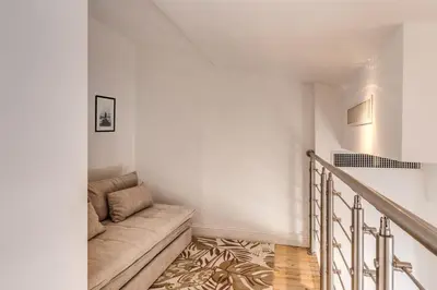 a living room with a couch and a staircase at Domus Sabina in Rome