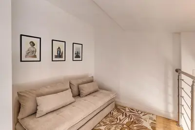 a living room with a couch and three pictures on the wall at Domus Sabina in Rome