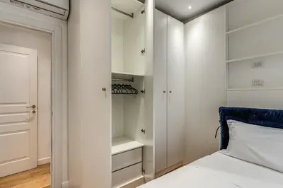 a bedroom with a bed and a closet at Domus Sabina in Rome