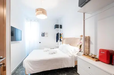 a bedroom with a white bed and a red suitcase at 4BNB - Reale House in Rome