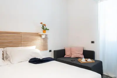 a bedroom with two beds and a table and a couch at 4BNB - Reale House in Rome