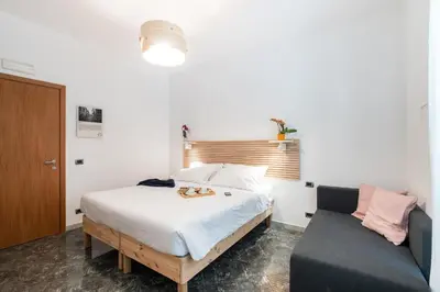 a bedroom with a bed and a couch at 4BNB - Reale House in Rome