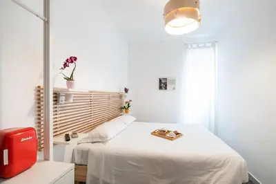 a white room with a bed and a red machine at 4BNB - Reale House in Rome