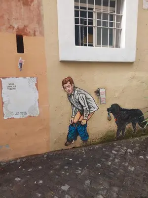 a painting of a boy and a dog on the side of a building at Borgo Pio 182 Vatican Suite in Rome