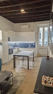 a kitchen with a table and chairs in a room at Borgo Pio 182 Vatican Suite in Rome
