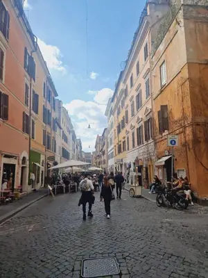 a group of people walking down a cobblestone street at Borgo Pio 182 Vatican Suite in Rome