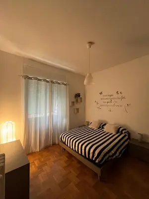 a bedroom with a bed with a black and white comforter at Balduina View in Rome