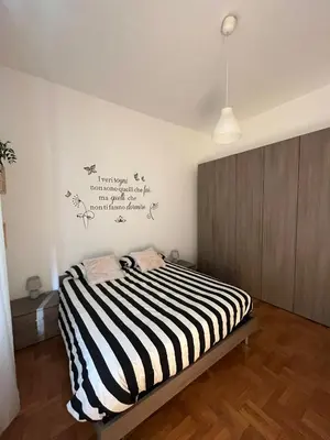 a bedroom with a bed with black and white stripes at Balduina View in Rome