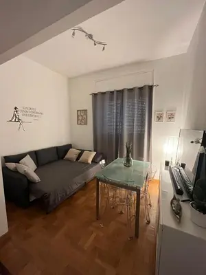 a living room with a couch and a glass table at Balduina View in Rome