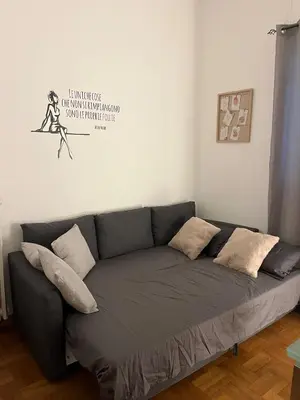 a living room with a gray couch with pillows at Balduina View in Rome