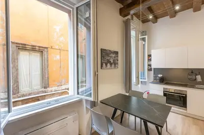 a small kitchen with a table and a window at Navona Modern by Rental in Rome in Rome
