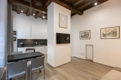 a kitchen and living room with a table and chairs at Navona Modern by Rental in Rome in Rome
