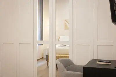 a room with a sliding glass door with a chair at Navona Modern by Rental in Rome in Rome