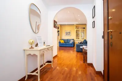 a living room with a table and a mirror at 81 mq, Stazione trastevere, Rome Sweet Home in Rome