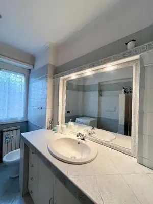 a bathroom with a sink and a large mirror at 81 mq, Stazione trastevere, Rome Sweet Home in Rome