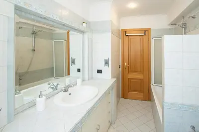 a bathroom with a sink and a tub and a mirror at 81 mq, Stazione trastevere, Rome Sweet Home in Rome