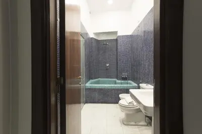a bathroom with a tub and a toilet and a sink at Casa Albani in Rome
