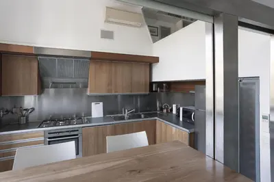 a kitchen with wooden cabinets and a wooden table at Casa Albani in Rome