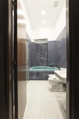 a bathroom with a tub and a toilet and a sink at Casa Albani in Rome