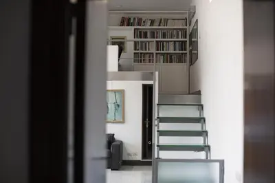 a staircase leading up to a room with books at Casa Albani in Rome