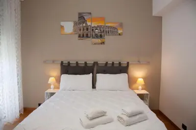 a bedroom with a white bed with pillows on it at RomAmo Sogliano4 in Rome