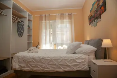 a bedroom with a white bed with a window at RomAmo Sogliano4 in Rome