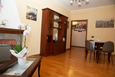 a living room with a table and a dining room at RomAmo Sogliano4 in Rome