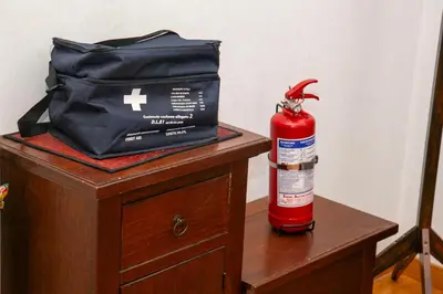 a fire extinguisher and a bag on a table at RomAmo Sogliano4 in Rome