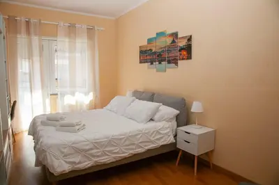 a bedroom with a bed and a painting on the wall at RomAmo Sogliano4 in Rome