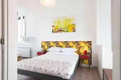 a bedroom with a bed and a painting on the wall at Trastevere novecento in Rome