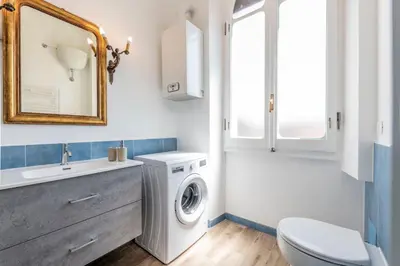 a bathroom with a washing machine and a sink at Trastevere novecento in Rome