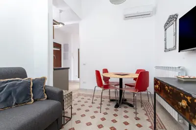 a living room with a couch and a table and chairs at Trastevere novecento in Rome