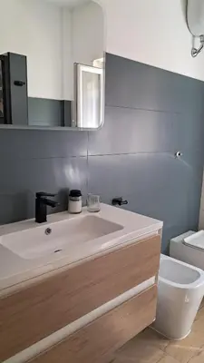 a bathroom with a sink and a toilet and a mirror at Roberta Rome Vatican Flat in Rome