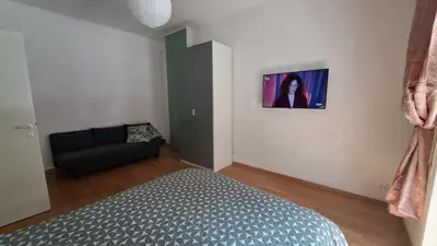 a bedroom with a bed and a black couch at Roberta Rome Vatican Flat in Rome
