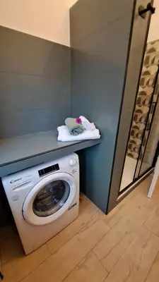 a washing machine in a laundry room with a counter at Roberta Rome Vatican Flat in Rome