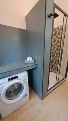 a washing machine in a bathroom with a mirror at Roberta Rome Vatican Flat in Rome