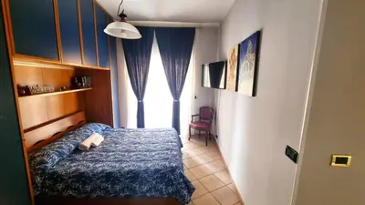a bedroom with two beds and a room with a tv at Bribry Home in Rome