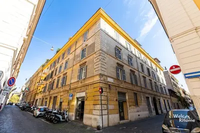 a large brick building with motorcycles parked on a street at Maison Borghetto - Vatican House in Rome