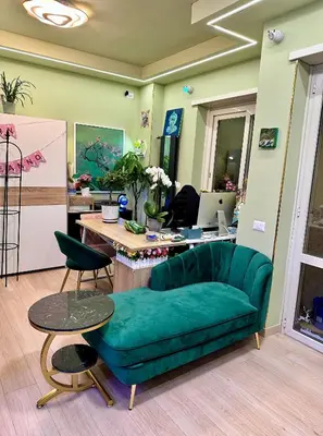 a living room with a green couch and a desk at Sanpaolo Modern Aesthetic B&B in Rome