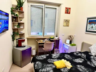 a room with a bed and a desk and a window at Sanpaolo Modern Aesthetic B&B in Rome