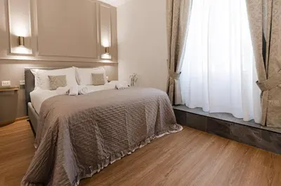 a bedroom with a large bed and a window at De Vince Suites - Luxury Rooms - Roma Termini in Rome