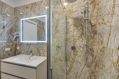 a bathroom with a sink and a shower at NAIF Suites in Rome