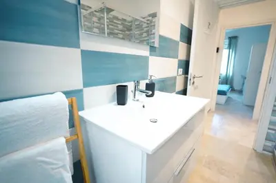 a bathroom with a white sink in a room at Salotto Tiburtino in Rome