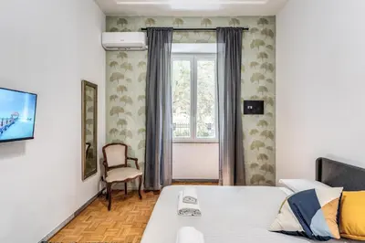 a bedroom with a bed and a window at Residenza Nemorense in Rome