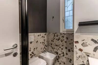 a bathroom with a toilet and a sink at Residenza Nemorense in Rome