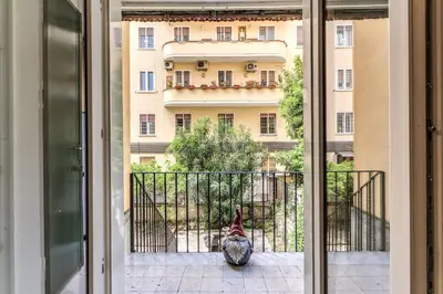 a chicken sitting on a balcony looking at a building at Residenza Nemorense in Rome