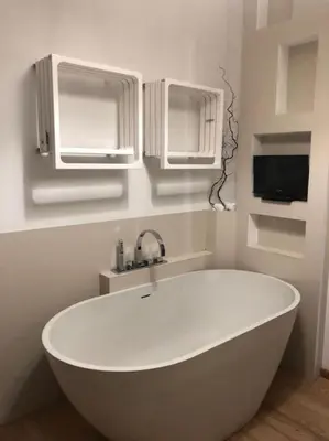 a white bath tub in a bathroom with a tv at La casa di Rosina al Pigneto in Rome
