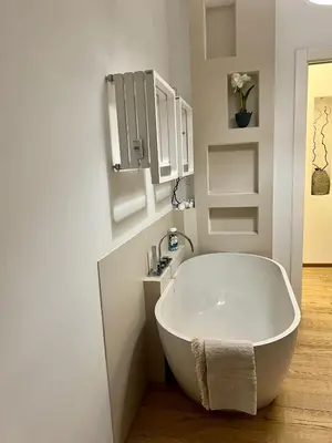 a white bath tub in a bathroom with a sink at La casa di Rosina al Pigneto in Rome